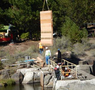 divers Setting new section of stop logs